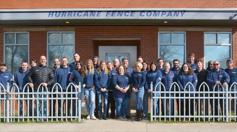Hurricane Fence Company team standing in front of office
