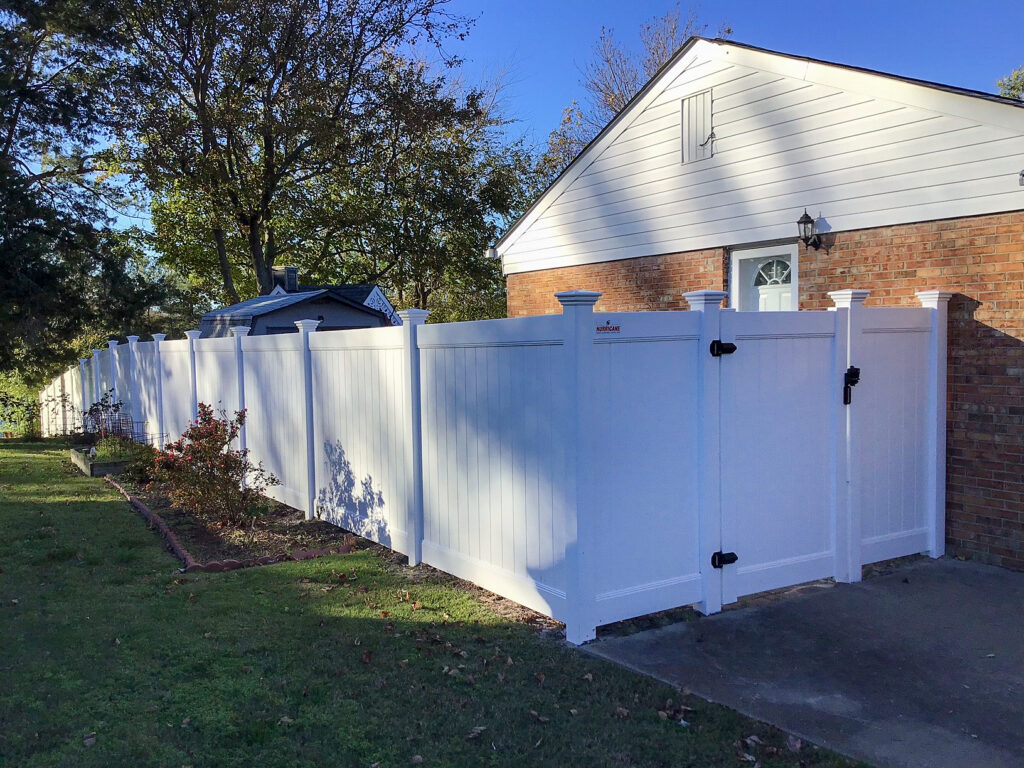 white residential vinyl fencing with post caps