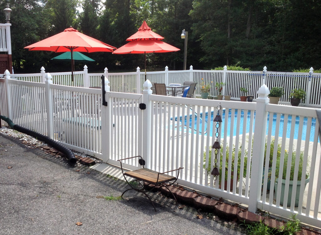 White vinyl fencing surrounding a residential pool